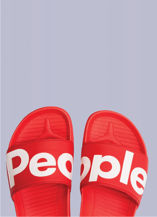 red flip flops on grey background